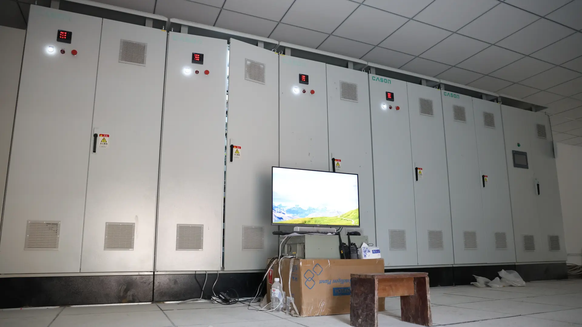 Indoor row of enclosed Cason fermentation units with control panels and ventilation grilles
